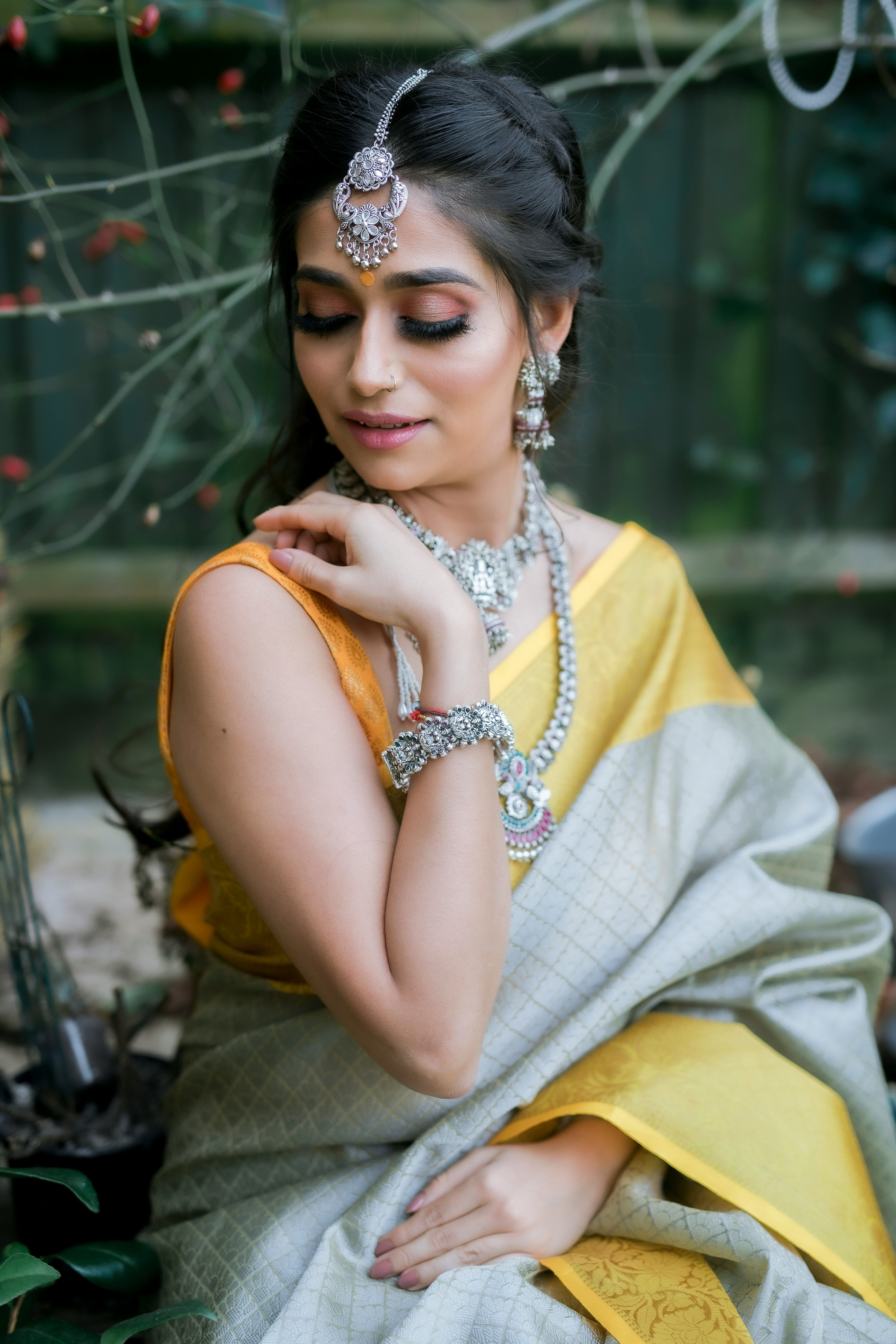 woman in yellow sleeveless dress wearing gold necklace